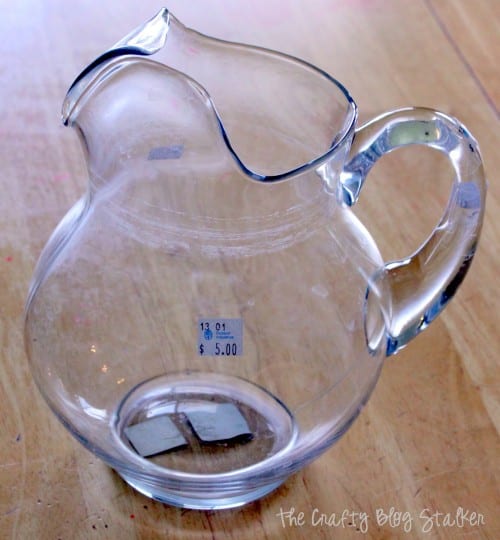 a clear glass pitcher with a $5 sticker