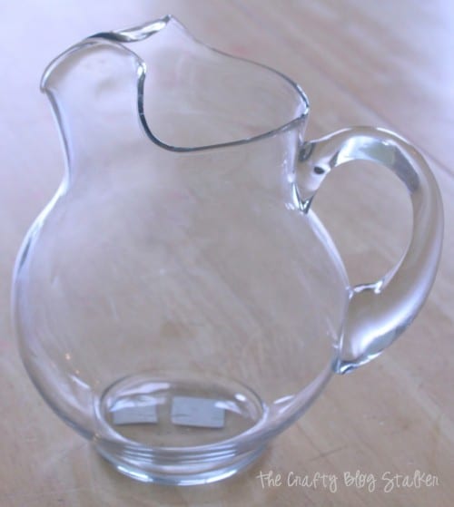 clean glass pitcher to be used as the vase for the lily bouquet