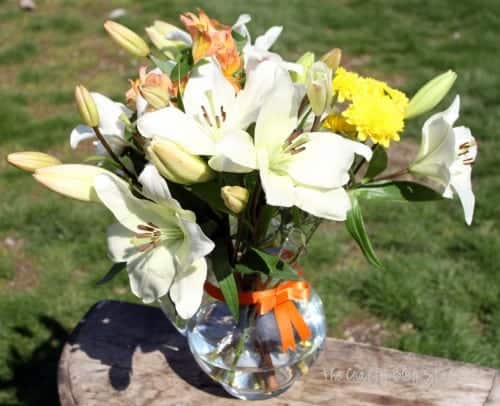 simple mixed flower lily bouquet on a wooden table