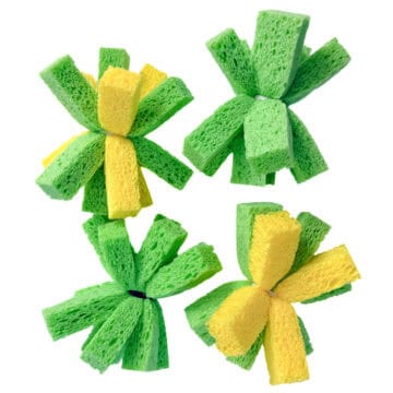 Four green and yellow DIY sponge water bombs made from sponge strips tied in the center, displayed on a white background.