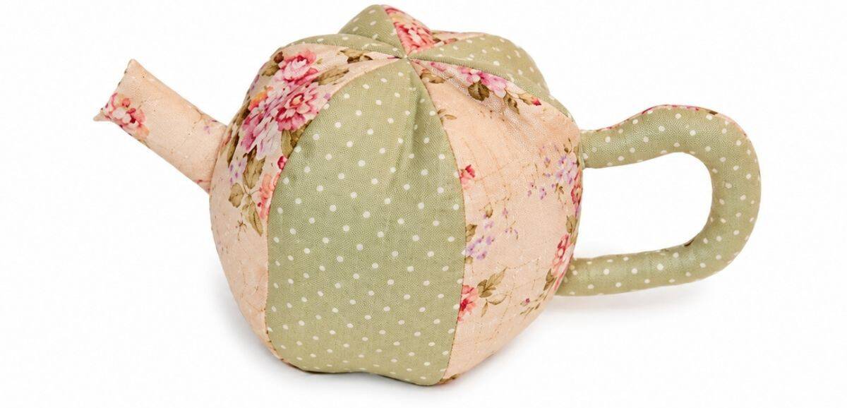 Finished fabric teapot body with floral and polka dot panels, attached handle and spout, sewn and stuffed for a soft toy tea set.