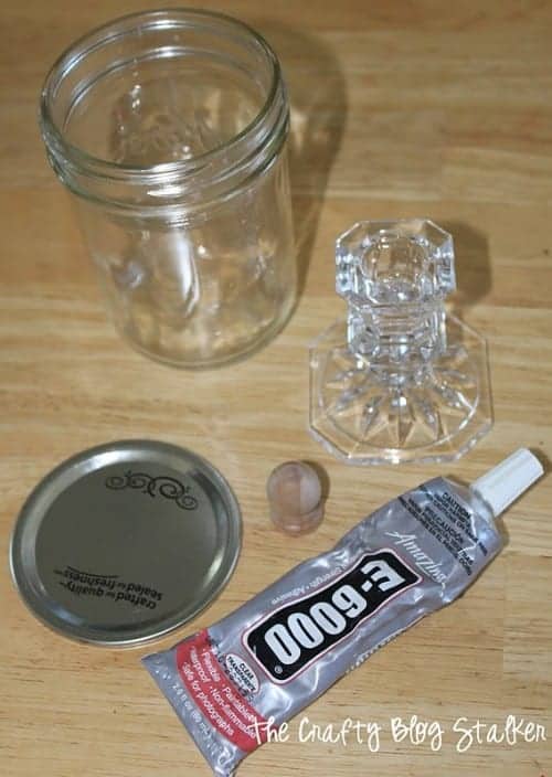 A glass pint jar, candlestick, e6000 glue, and a wood knob.