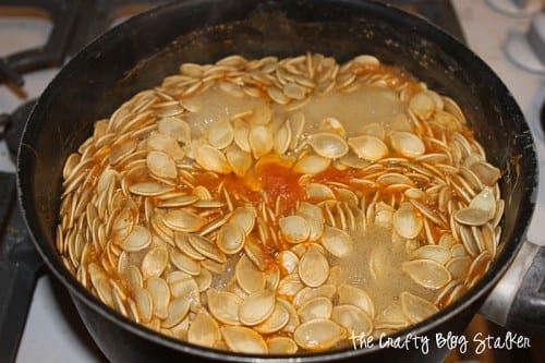 fresh pumpkin seeds boiling in a pot of salt water