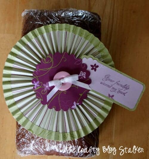 a gift of banana bread with a rosette gift topper