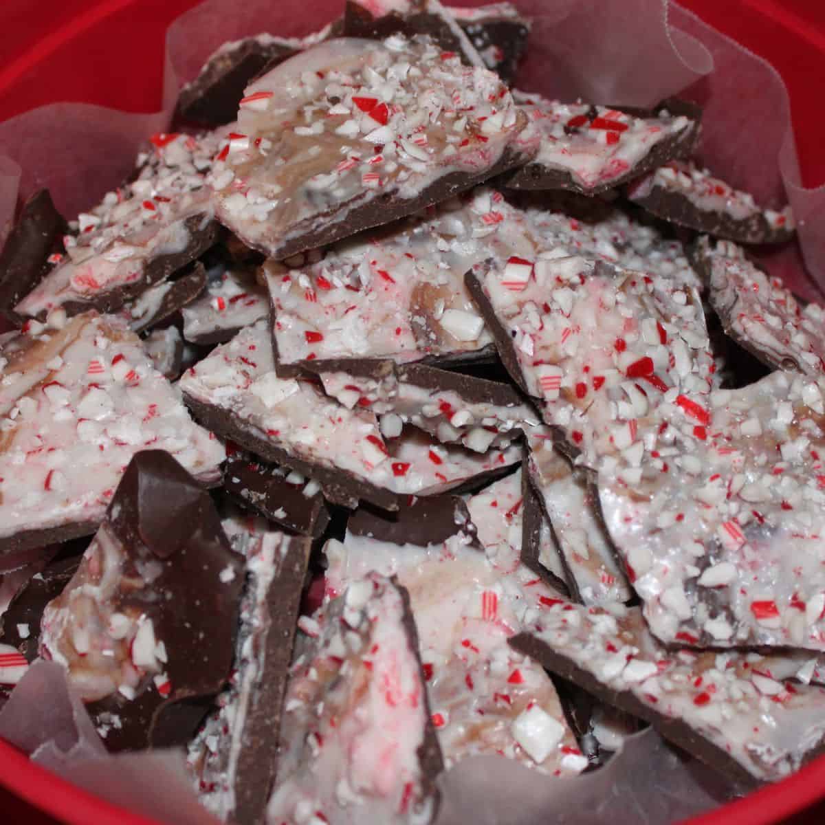 Peppermint bark recipe in a red plastic container.