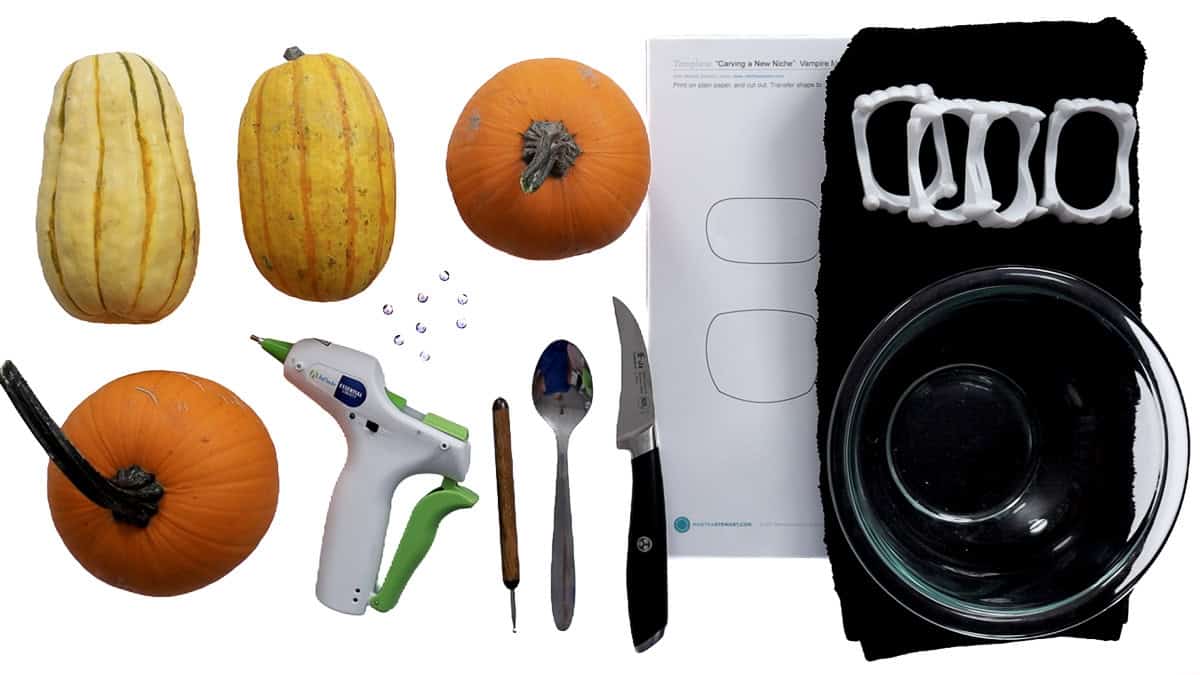 Supplies for vampire pumpkins including mini pumpkins, gourds, plastic fangs, googly eyes, hot glue gun, knife, spoon, carving tool, and bowls.