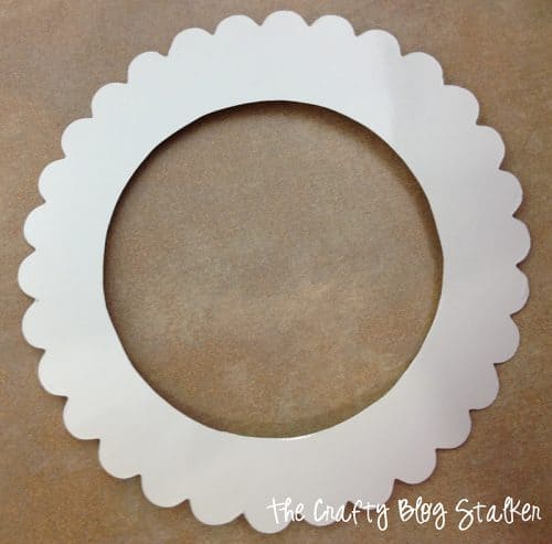 a white scallop circle cut out of cardstock