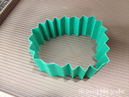 a strip of green paper with accordion folds to make a lollie