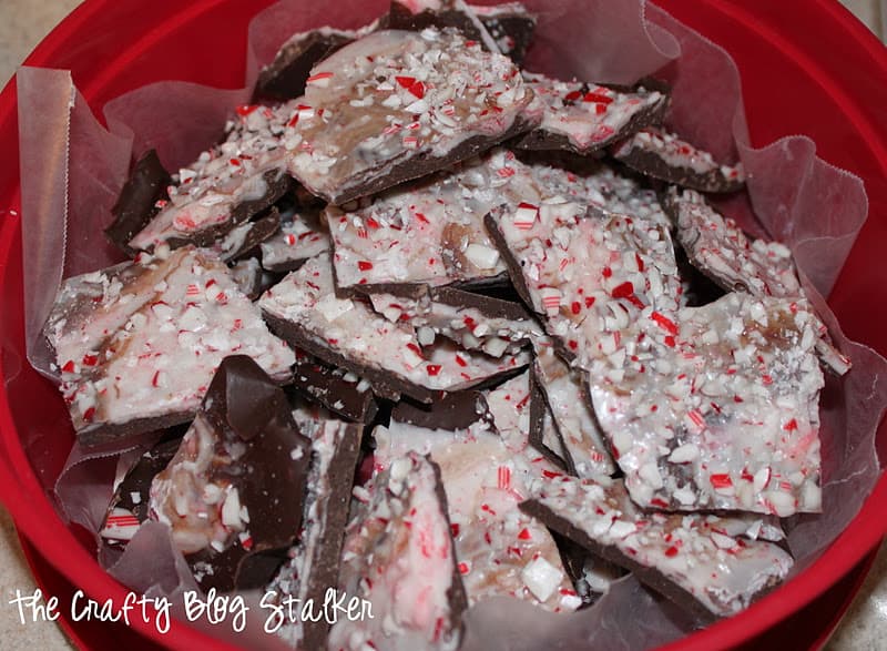 Pieces of peppermint bark in a red bowl, ready to gift.