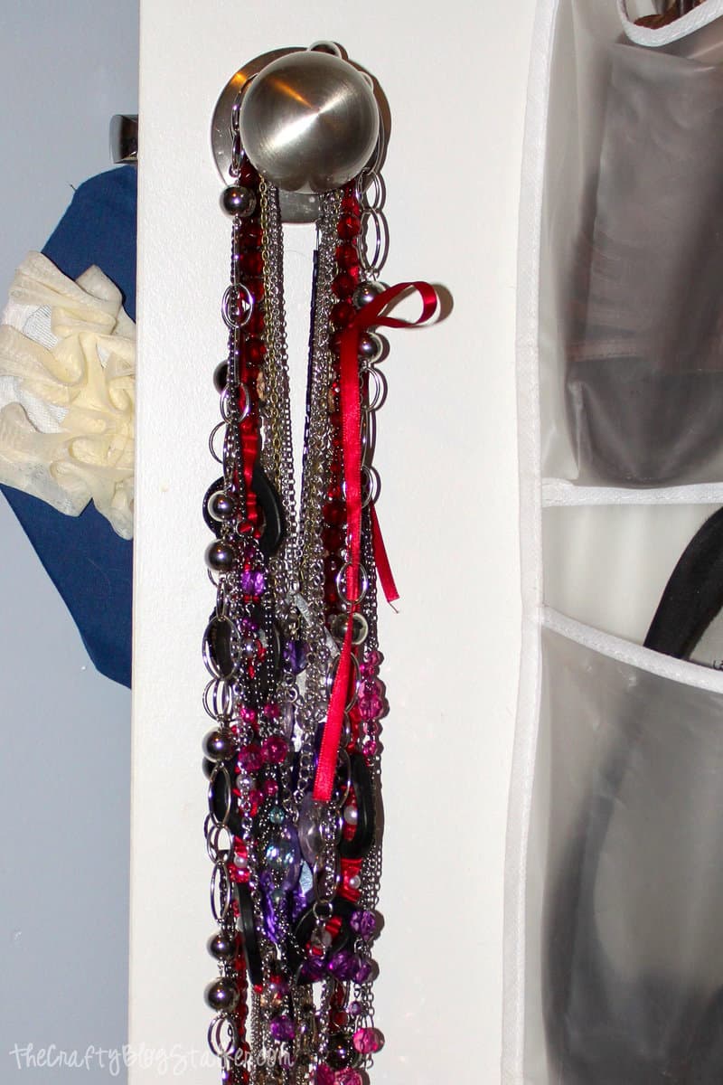 necklaces hanging on a door knob