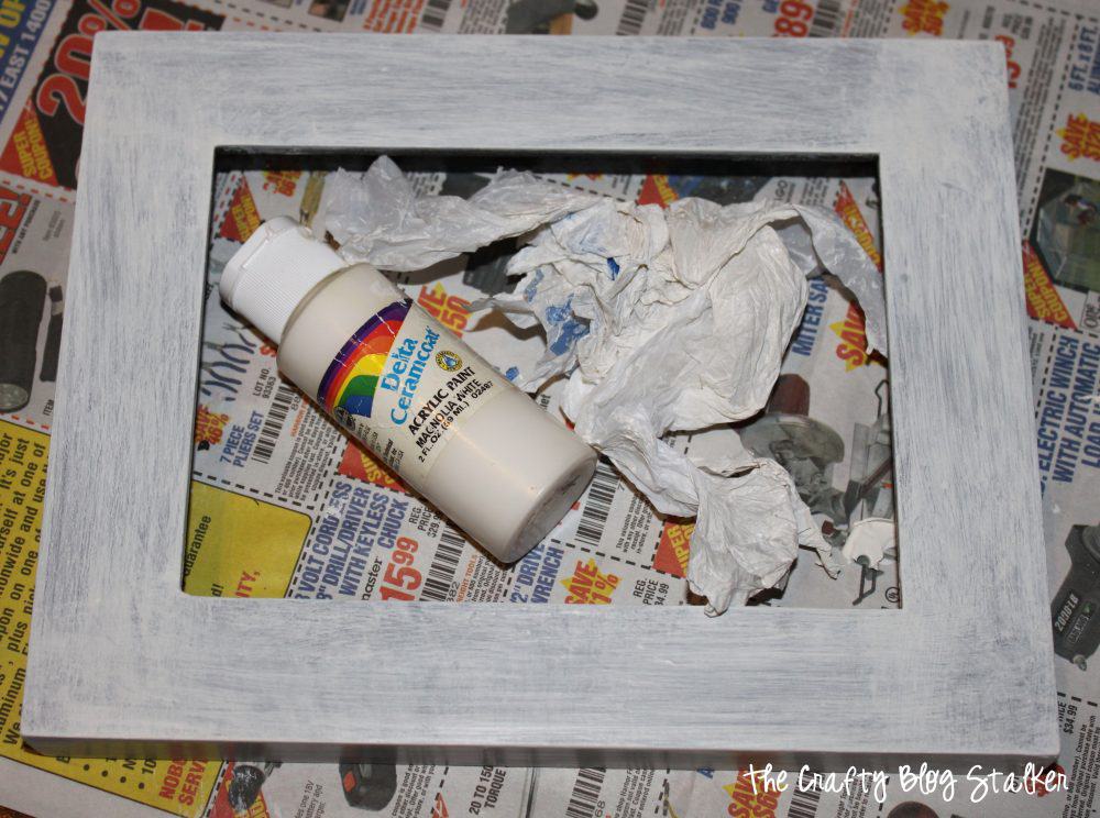 A wooden frame with distressed painting.