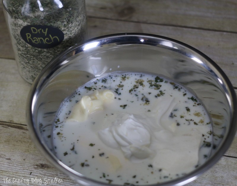 combining the ingredients to make creamy ranch dressing