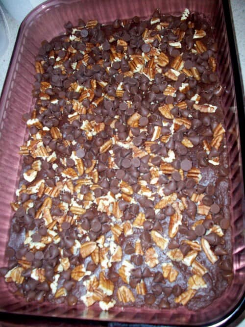 nuts and chocolate layered on the brownies
