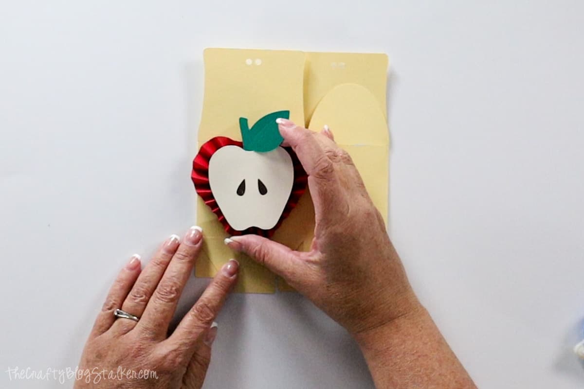 placing the apple rosette on the box.