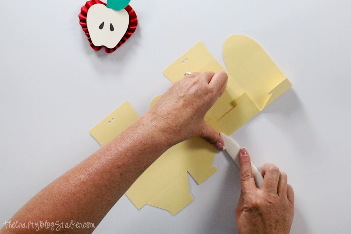 Folding the flaps of the box with a bone folder.