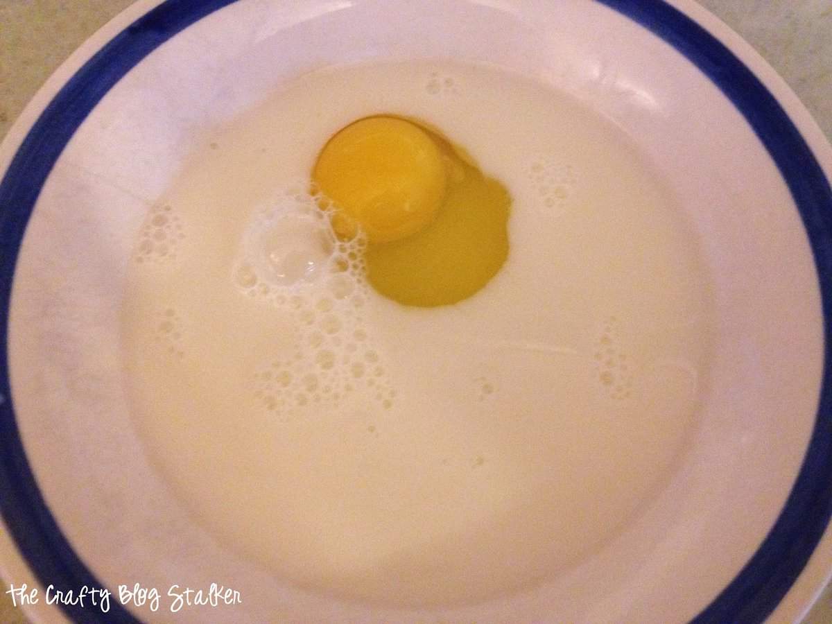A bowl with milk and an egg.