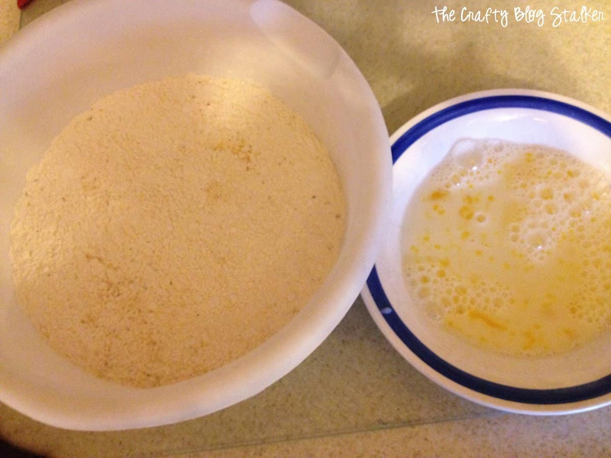 Two bowls, one filled with a dry mixture and the second is filled with a wet mixture.