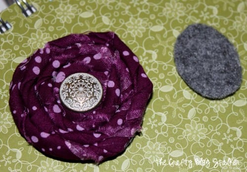 an image of the fabric rolled flower and a circle of felt