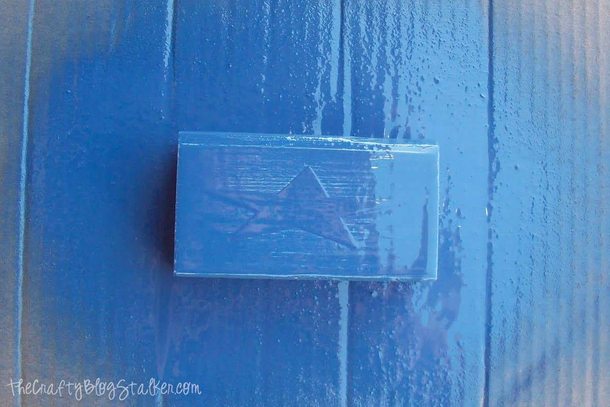 a block of wood spray painted blue
