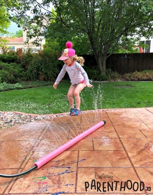 image of a girl jumping in a Pool Noodle Sprinkler