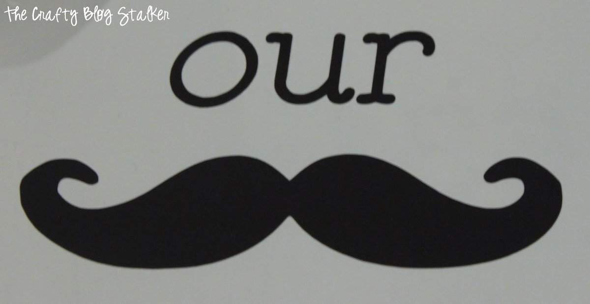 "Our stache" cut out of brown vinyl.