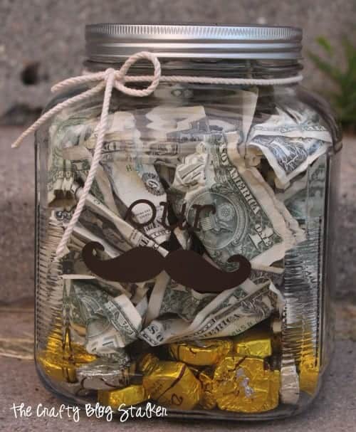 Money jar with vinyl that reads "our Stache" to give as a wedding gift.