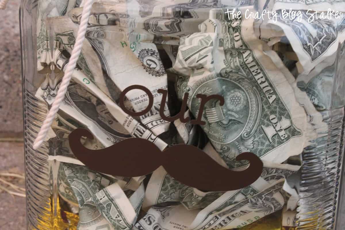 Close-up of the "our stache" cut out of brown vinyl on the glass jar.
