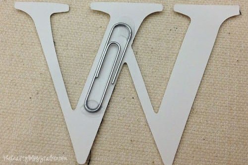 a paper clip glued onto the back of the letters