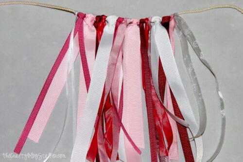 tying on ribbon to a rope