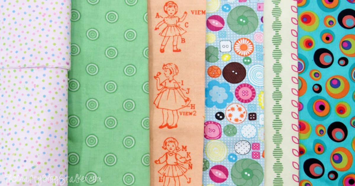 A colorful assortment of fabric patterns featuring polka dots, circles, vintage sewing illustrations, and playful designs, perfect for crafting and sewing projects.