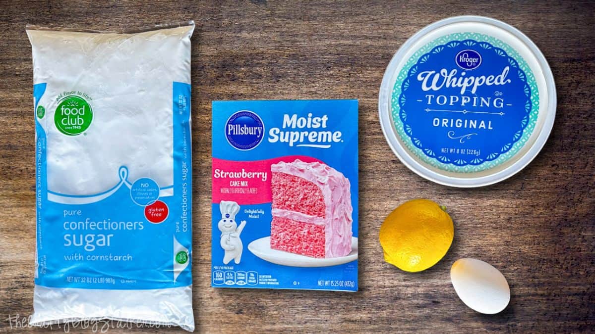 Pink Lemonade Cookie Ingredients Pink lemonade crinkle cookies arranged in neat rows on a baking sheet, dusted with powdered sugar and baked until cracked on top.