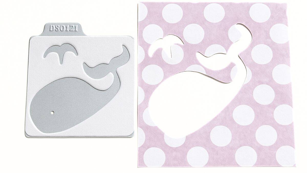 Metal whale die cut and a pink polka dot paper piece showing the whale and water spout shapes cut out, ready for use as a stencil or applique.