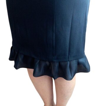 Black dress with added ruffled lace trim at the hem, extending the length and creating a stylish flared detail.