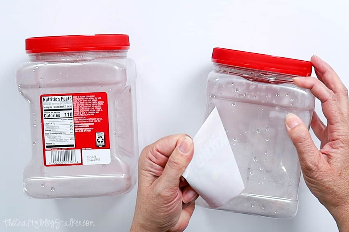 Removing the label from the plastic container.