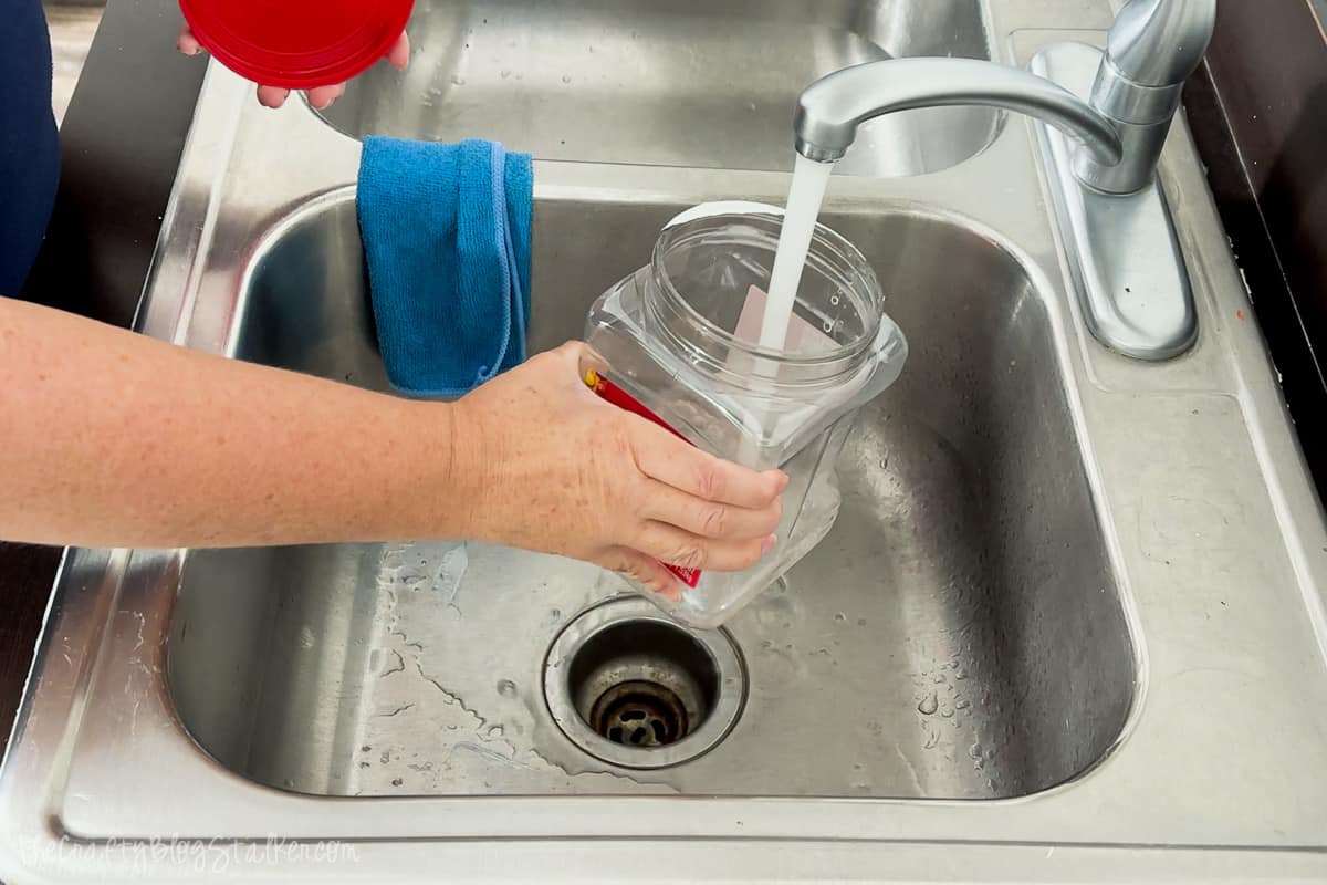 Filling plastic container with hot tap water.
