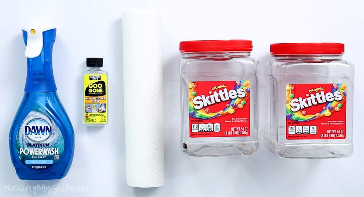 Dish soap, goo gone, paper towels, and two empty skittles containers.