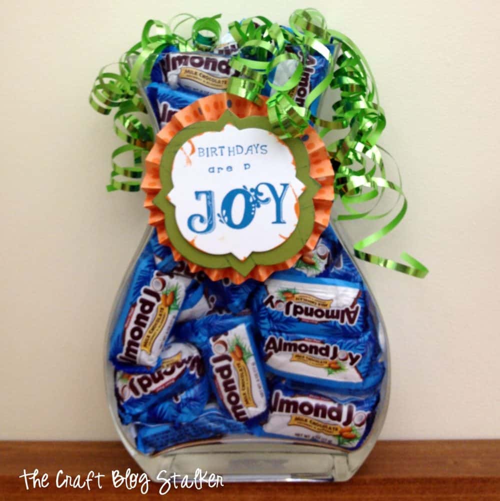 Birthday candy jar filled with almond joy candy bars.