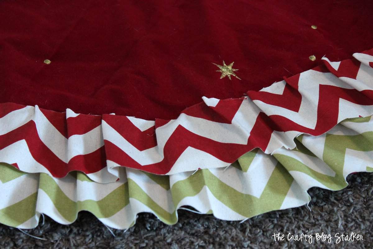 gluing strips of fabric onto a tree skirt base to create a new tree skirt
