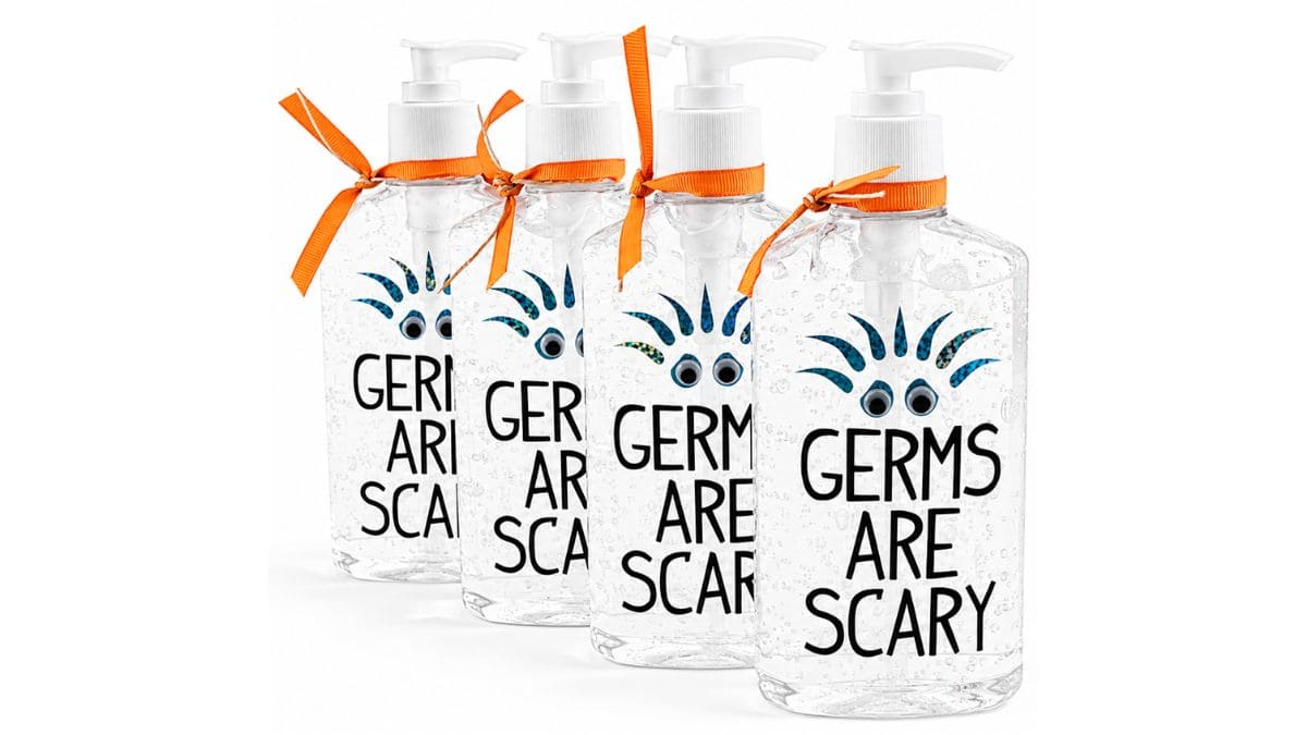 Four decorated hand sanitizer bottles with "Germs Are Scary" vinyl decals, googly eyes, and orange ribbon, arranged as funny DIY teacher appreciation gifts.