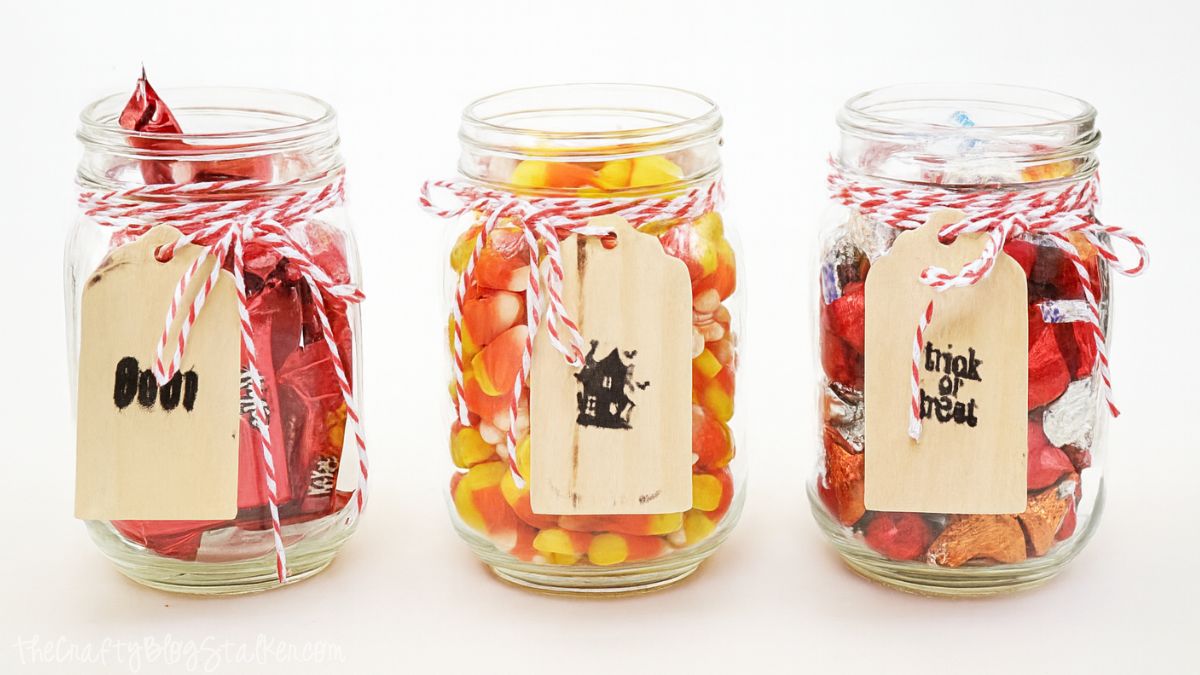 Cherished Bliss: Candy Filled Mason Jars #masonjars #Halloween Three mason jars filled with Halloween candy, each tied with red and white twine and wooden tags reading