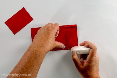 applying glue to the tabs of the gift card holder