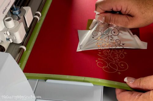 peeling back the foil from red cardstock