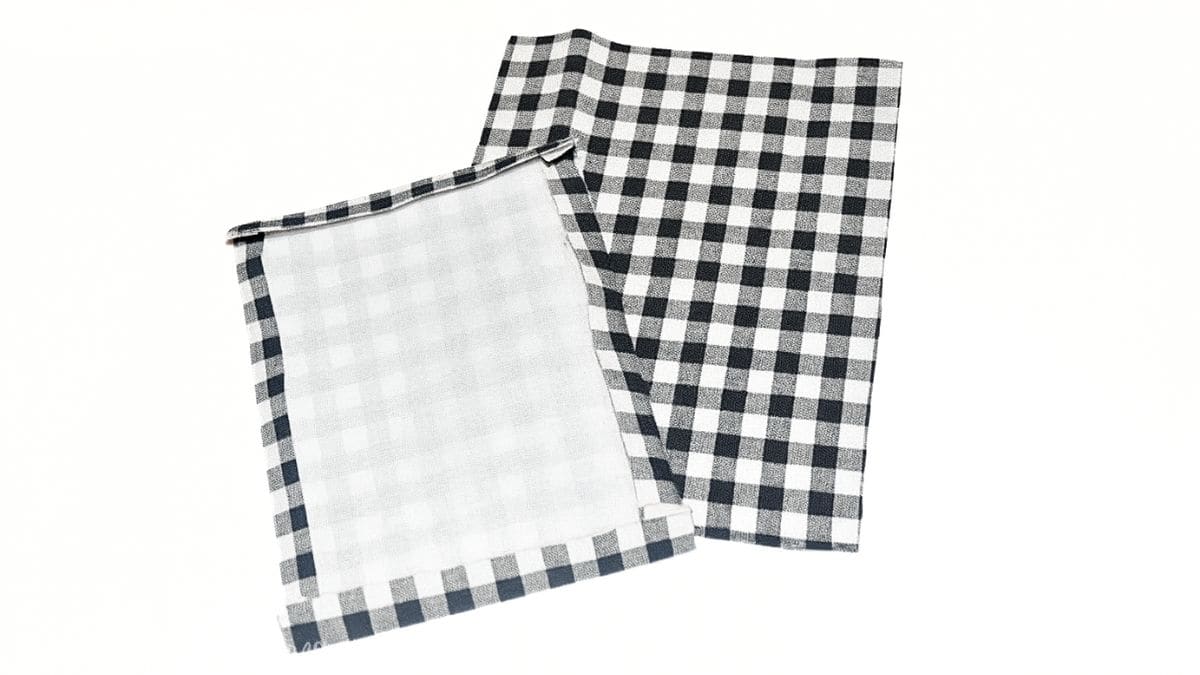 Two black-and-white gingham fabric pieces are shown, each with folded and stitched edges ready to be sewn into pockets.