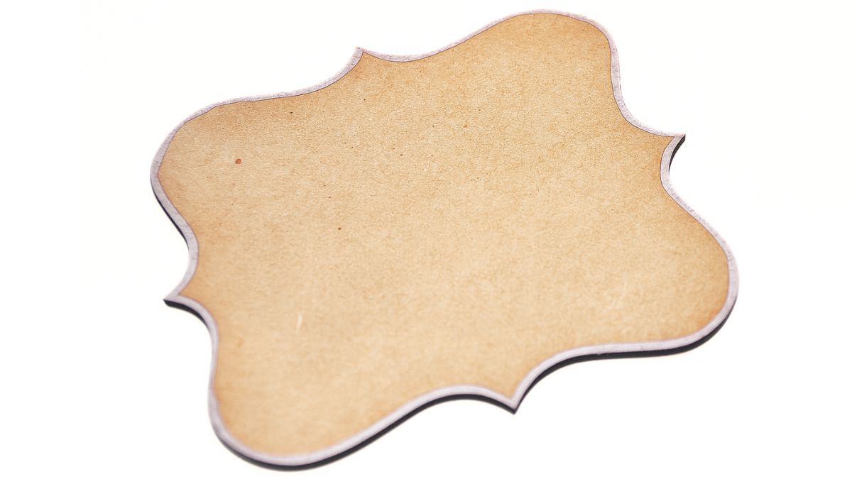 A single unfinished wood plaque with a decorative scalloped shape lying flat on a white background.