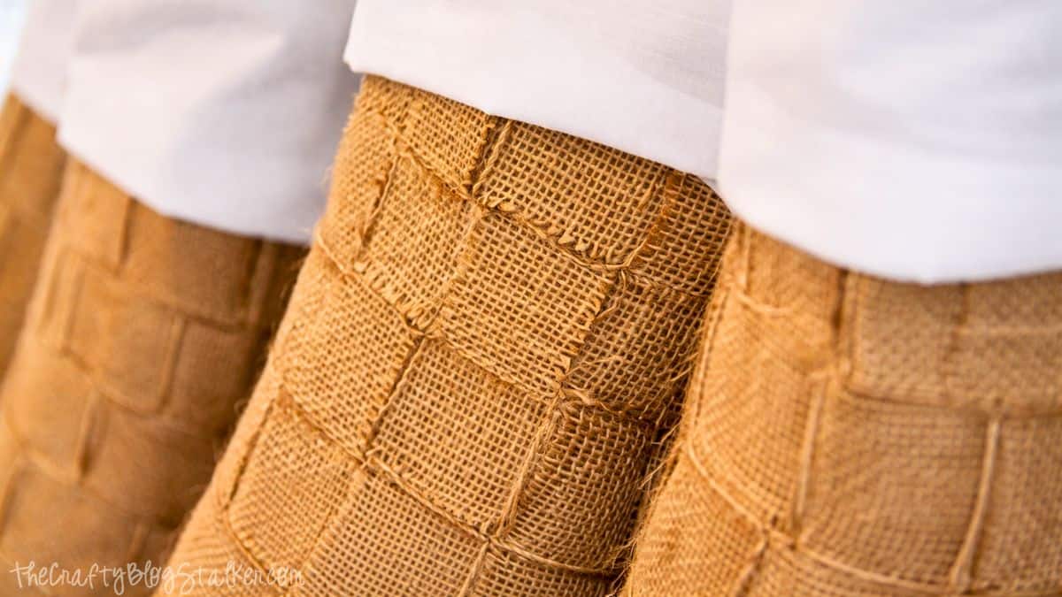Weaved Burlap Christmas Stockings Tutorial Close-up of handmade burlap Christmas stockings showing the woven burlap texture and folded fabric cuffs at the top.