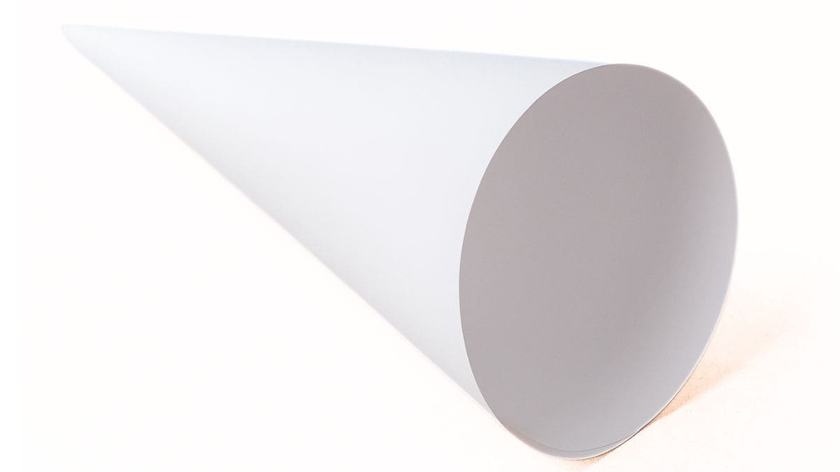 A plain white paper cone lying on its side against a light background.