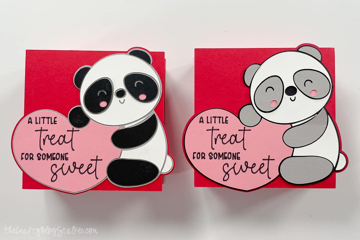 Two boxes, one with a gray panda and the other is a black panda.
