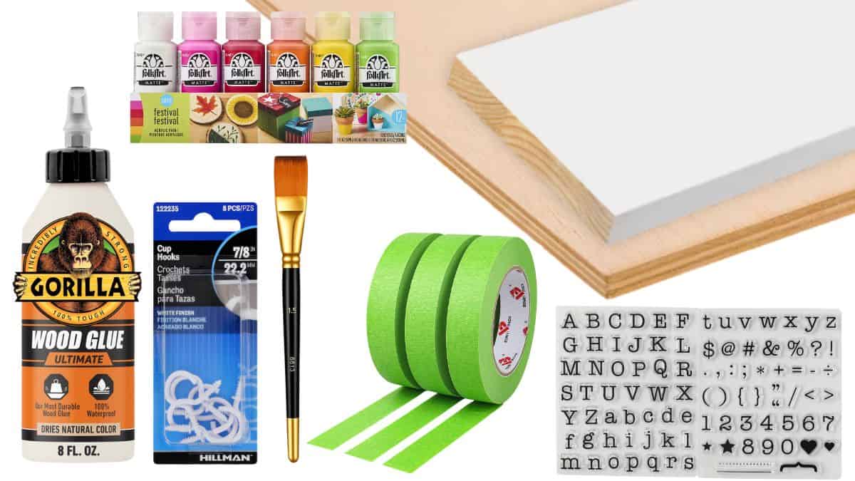Craft supplies including wood board, paint bottles, brush, painter's tape, wood glue, cup hooks, and alphabet stamps arranged on a white background.
