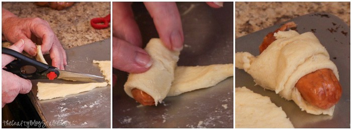 Cutting crescent dough pieces in half and rolling them with a lil' smokie inside.