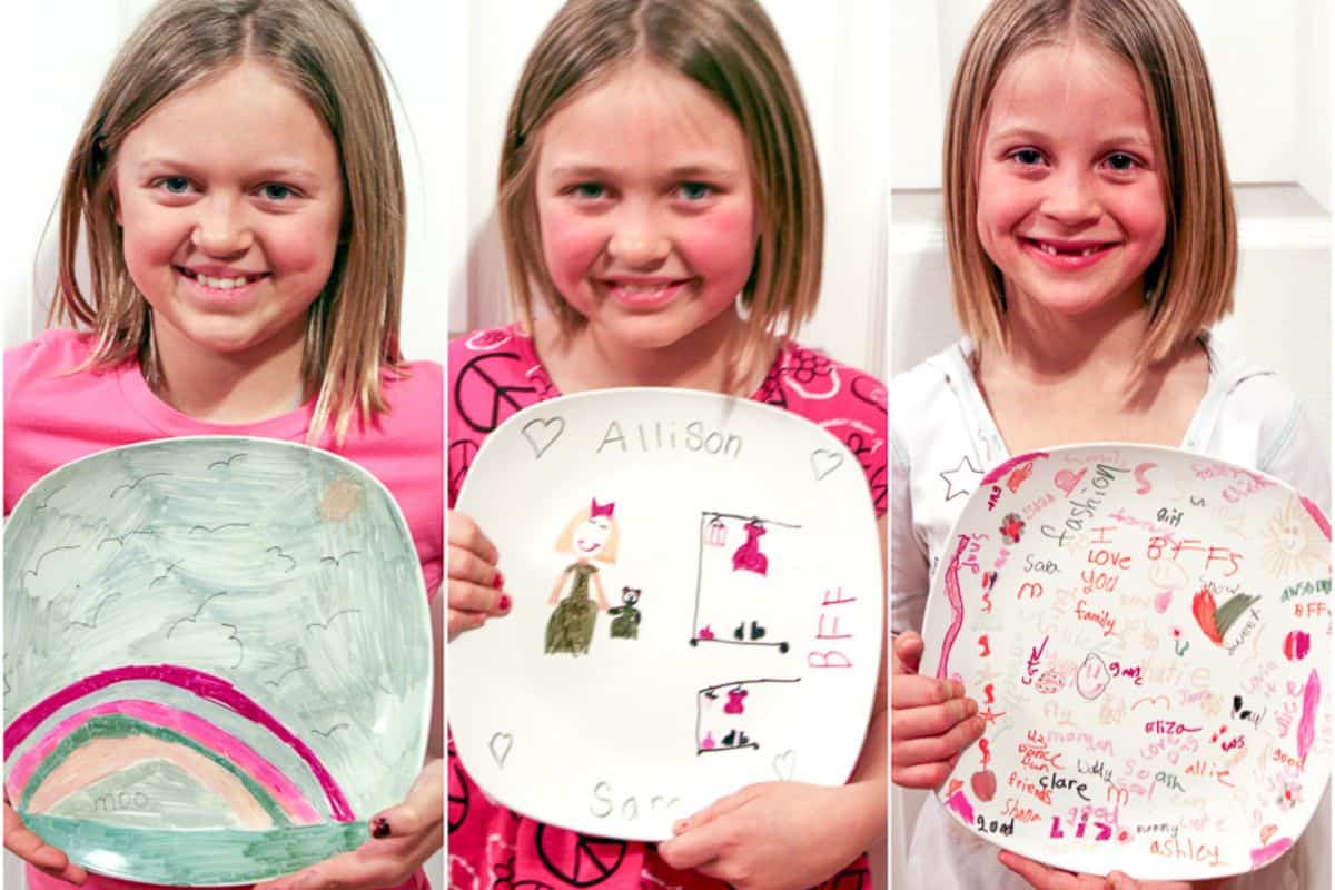 Three kids holding their baked sharpie plates.